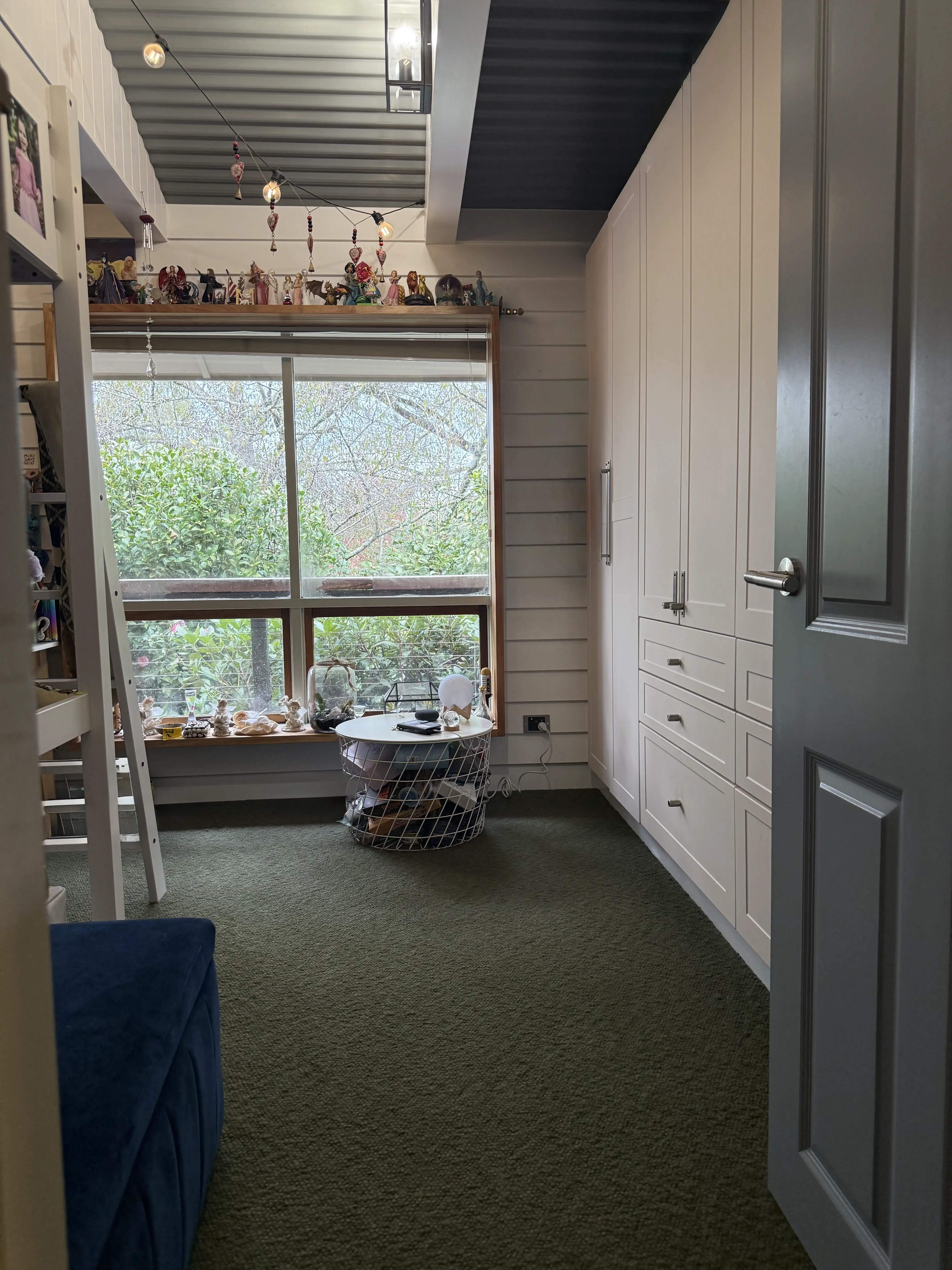 Kids room / retreat with built-in cabinetry and corrugated ceiling