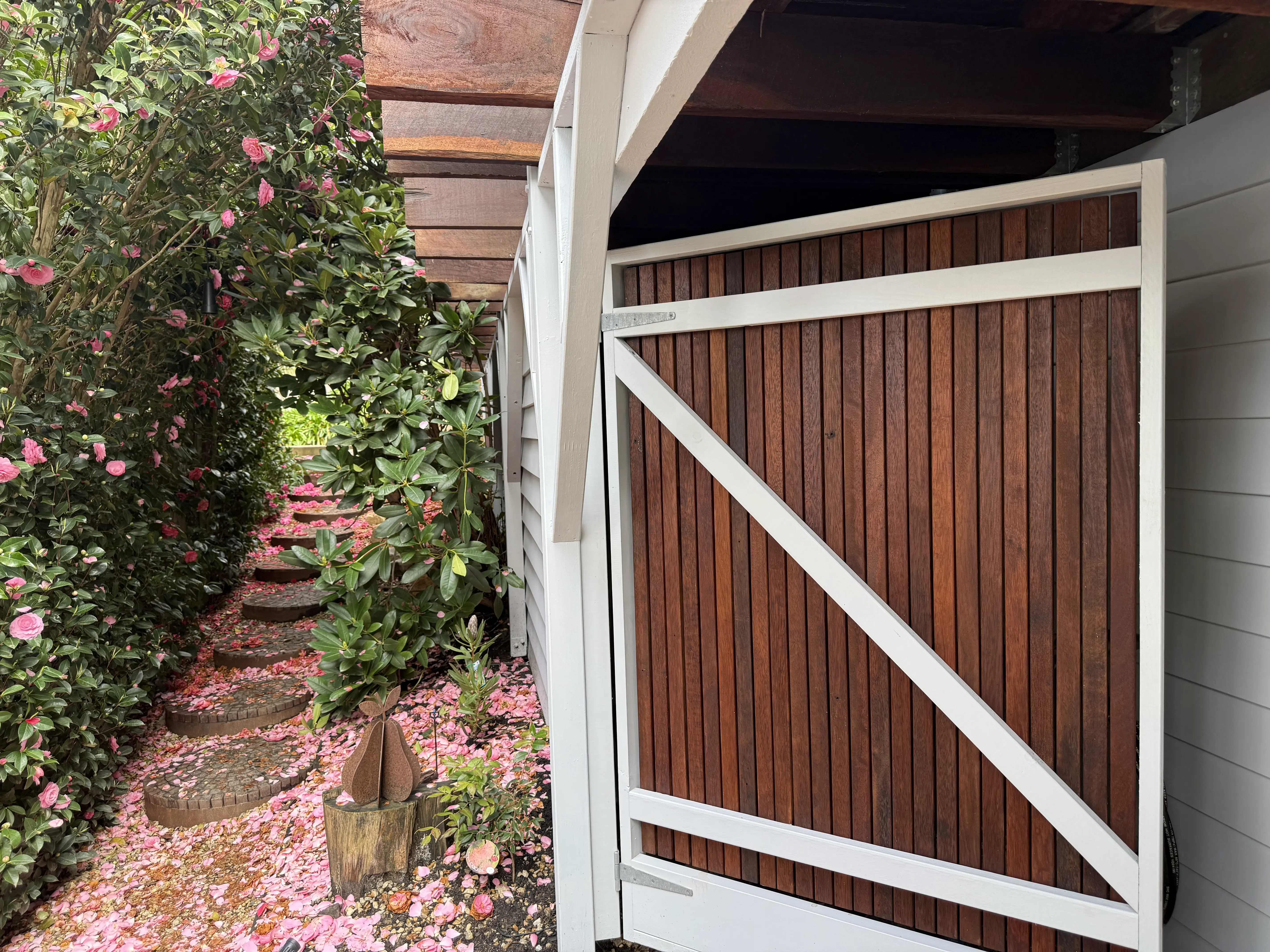 Custom slatted timber gate under deck